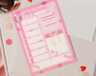 May include: A pink weekly planner with a disco ball graphic, polka dots, and the words "Weekly Planner" at the top. The planner has sections for each day of the week, a to-do list, and a notes section. Decorative elements include stars and a bow.