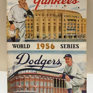 May include: Vintage 1956 World Series program featuring the Yankees and Dodgers. The cover art depicts baseball players and stadiums in vibrant colors. The Yankees section shows a player yelling, while the Dodgers section shows a player kneeling.