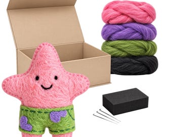 May include: A needle felting kit featuring a pink star-shaped figure wearing green shorts with purple spots, a cardboard box, four bundles of wool roving in pink, purple, green, and black, a black foam block, three needles, and text reading INSTRUCTIONS INCLUDED.
