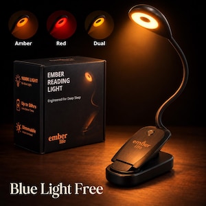 May include: A black Ember Reading Light with a flexible neck and clip base, emitting a warm amber glow. The packaging box displays the text Ember Reading Light, Engineered For Deep Sleep, 1600K Light, Up to 50hrs, Dimmable, and Blue Light Free.