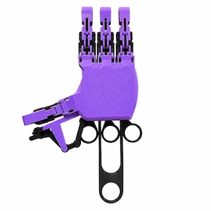 May include: A purple and black articulated mechanical hand device featuring three finger segments with black joints, a palm section, and a black control mechanism with three circular finger loops extending from the base for manual operation.