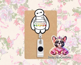 May include: A retractable badge reel featuring a white and black Baymax character with a pain assessment tool. A cartoon French Bulldog in a pink dress and crown is also present. The background is a floral pattern.
