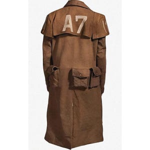 May include: A brown duster coat with the white text "A7" on the back. The coat has a cape-like collar and multiple pockets. The coat is made of a durable material.
