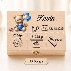 May include: A rectangular wooden keepsake box featuring a printed illustration of a teddy bear in blue overalls holding balloons. The box displays the name Kevin, the date July 12 2026, 17:58pm, 3,228 g, and 50CM, alongside icons of a baby bottle, calendar, clock, scale, and ruler.