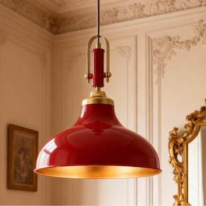 May include: A red pendant light with a gold interior and brass detailing. The light fitting has a rounded, bell-shaped shade and is suspended from the ceiling. The design is classic and elegant.