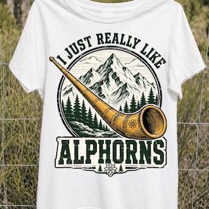 May include: White t-shirt featuring a graphic of an alphorn, mountains, and pine trees. The text reads "I JUST REALLY LIKE ALPHORNS". The alphorn is a long, wooden wind instrument, and the design has a vintage, outdoorsy feel.