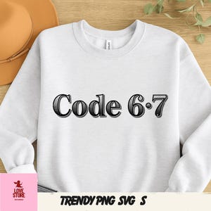 May include: White sweatshirt with the text "Code 6.7" in a black, decorative font. The sweatshirt is a crew neck style. The words "TRENDY PNG SVG S" are at the bottom of the image.