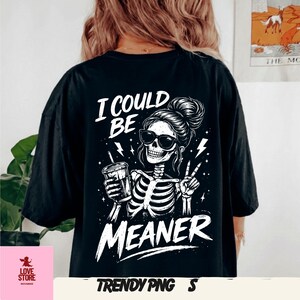 May include: Black t-shirt with a white graphic of a skeleton wearing sunglasses, holding a drink, and giving a peace sign. The text reads "I COULD BE MEANER". The shirt is from Trendy PNG.