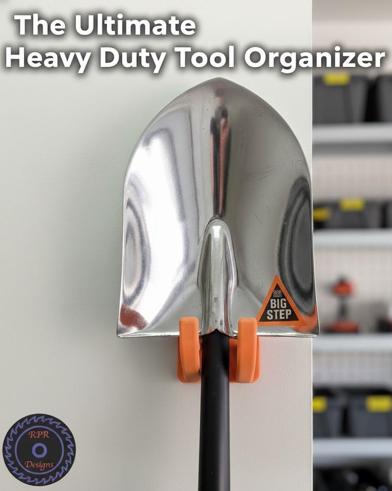Orange heavy-duty garage tool mount installed on a wooden wall holding a large metal shovel.