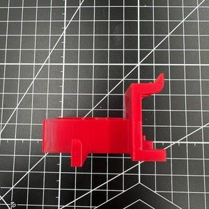 Side profile of a 3D printed mount showing the heavy-duty 4mm reinforced pegs designed for 1/4 inch pegboard holes.
