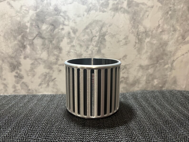 A professional silver and black two-tone desk organizer featuring a minimalist ribbed design for a sleek gaming or office aesthetic.