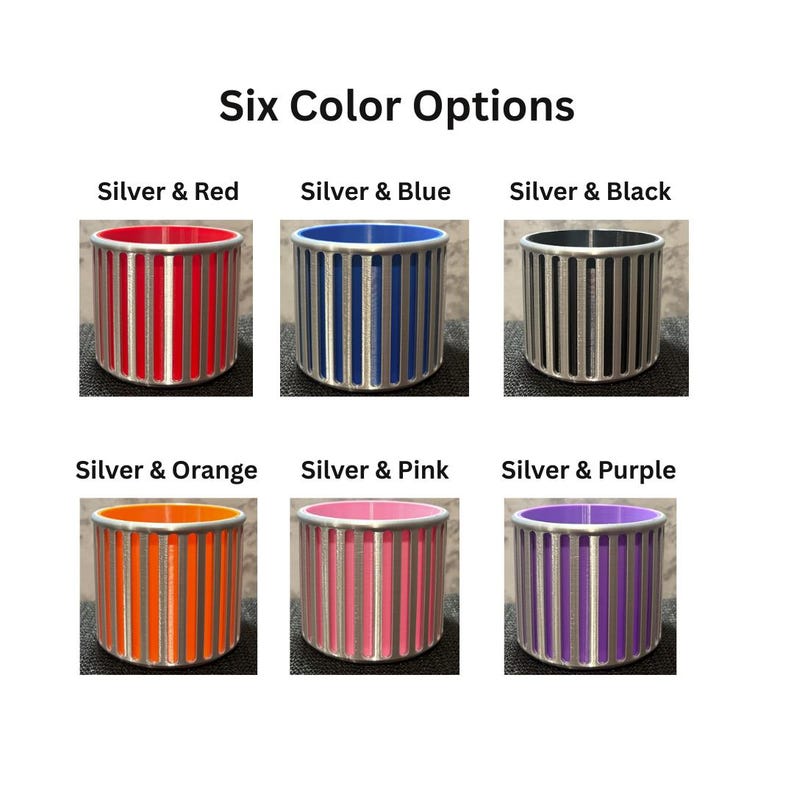 A grid titled Six Color Options displaying the silver architectural pencil holder with interior colors in Red, Blue, Black, Orange, Pink, and Purple.