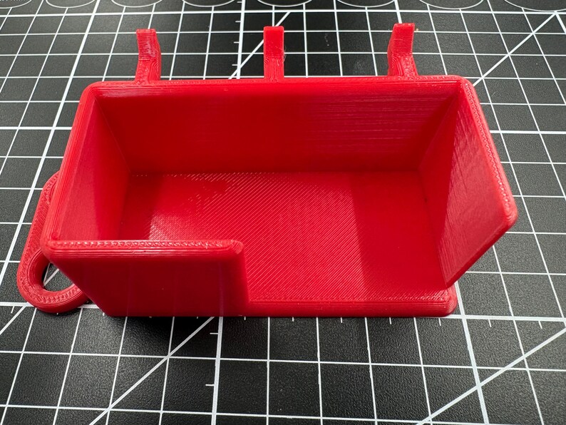 Front-facing view of the red holder showing the 39mm wide access cutout designed for easy tool grabbing and cable clearance.