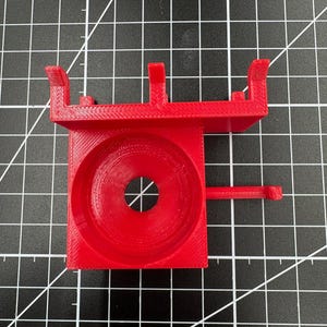 Top view of a red 3D printed tool mount showing the 38mm tapered opening designed to fit most soldering iron handles.
