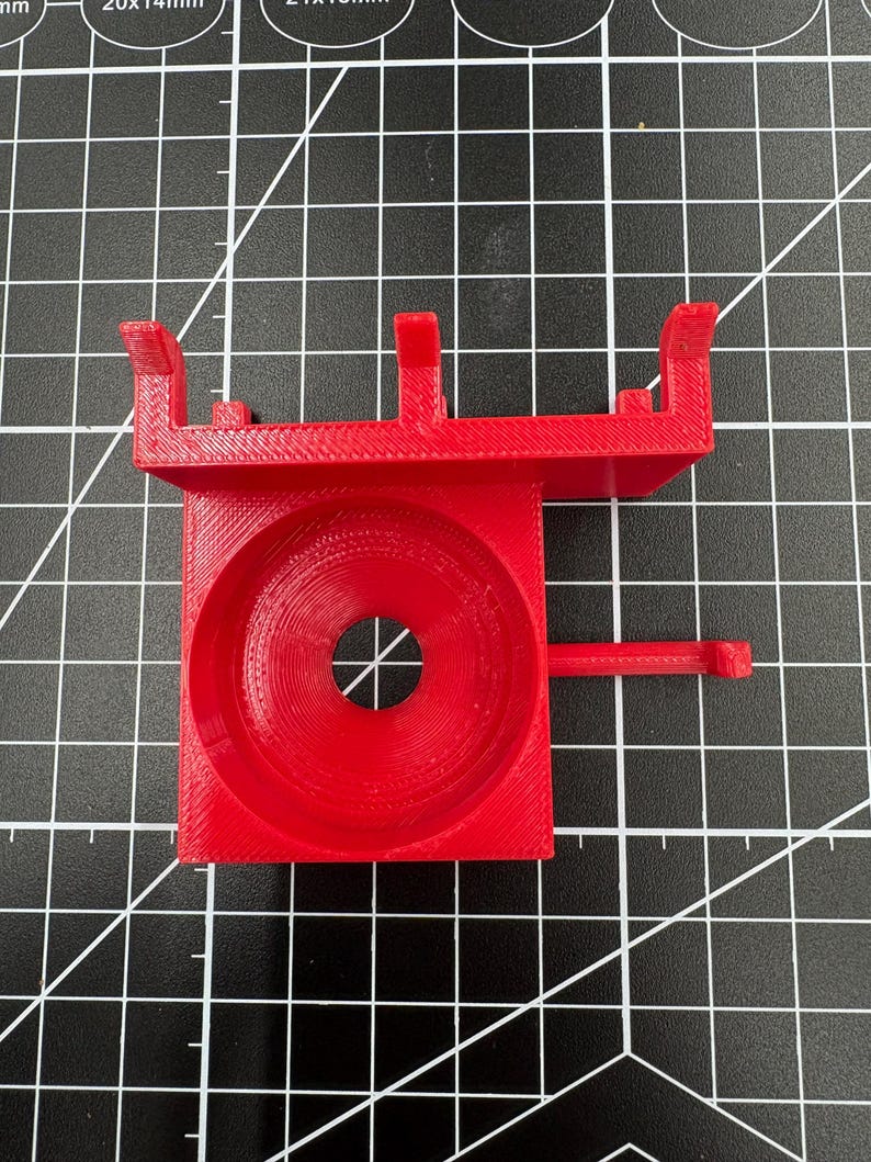 Top view of a red 3D printed tool mount showing the 38mm tapered opening designed to fit most soldering iron handles.