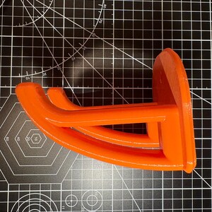 Side view of the orange tool mount highlighting the reinforced structural truss design for maximum weight support.