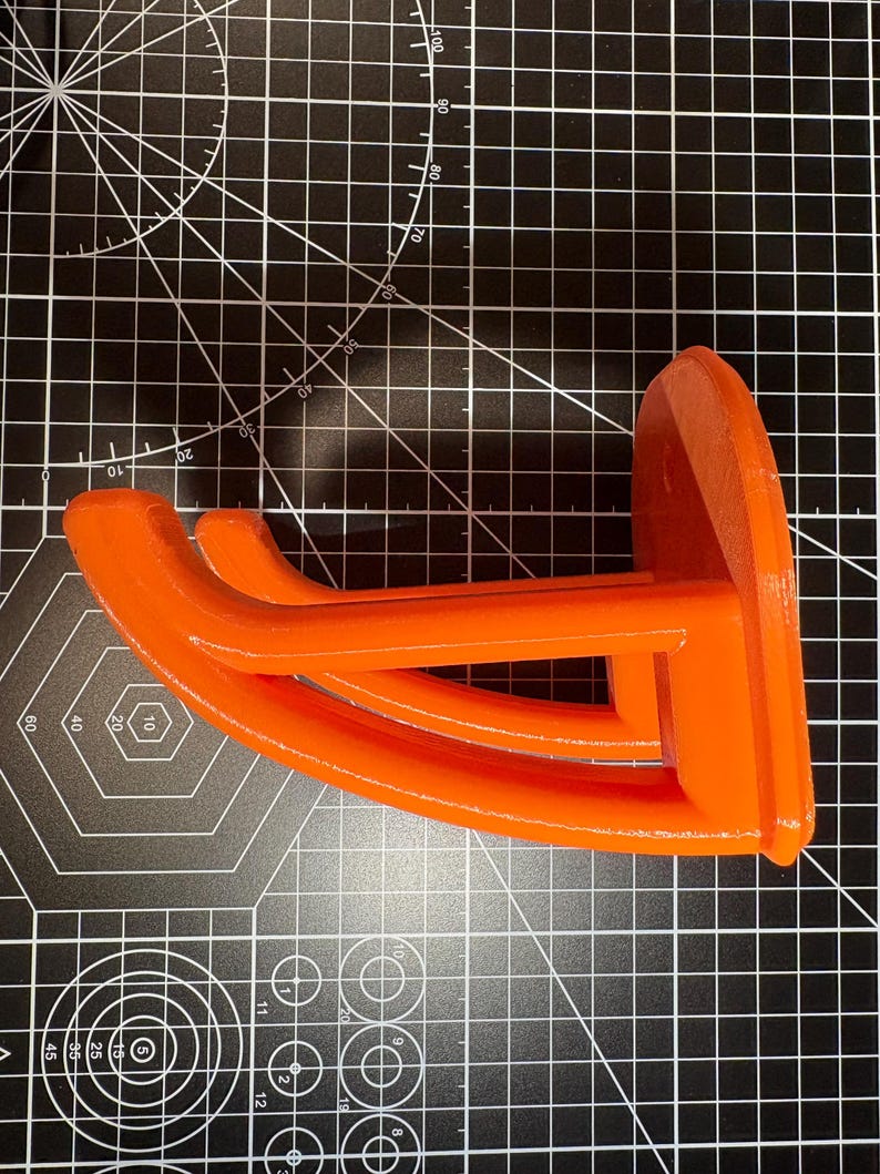 Side view of the orange tool mount highlighting the reinforced structural truss design for maximum weight support.
