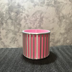A minimalist silver ribbed tool holder with a bright pink interior, showcasing a smooth 3D printed finish and geometric lines.