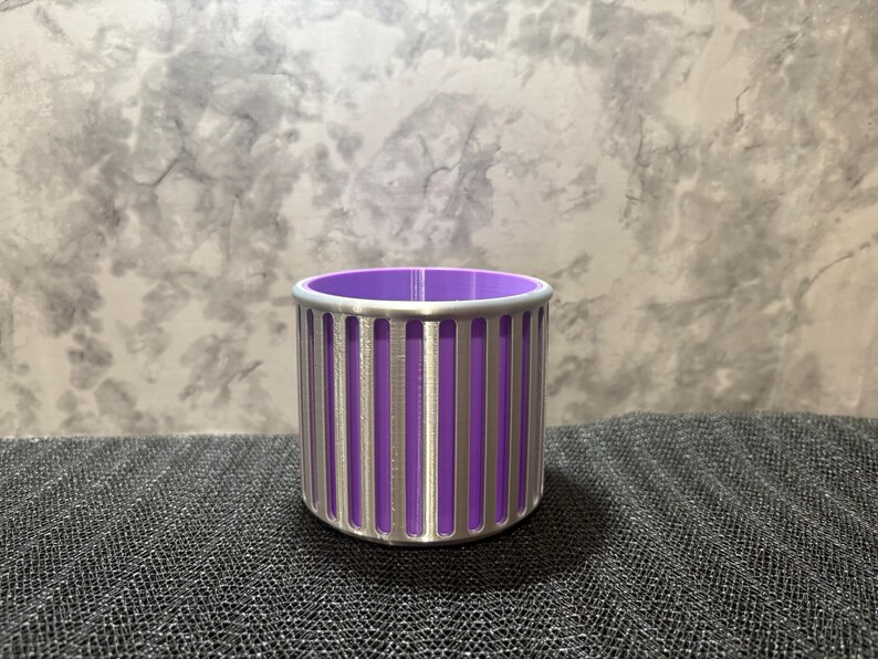 A futuristic silver and purple vertical-slotted desk accessory designed for designers and tech enthusiasts.