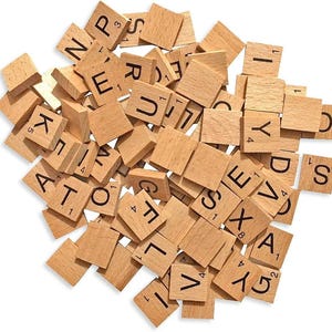 May include: A collection of wooden Scrabble tiles, each with a letter and a point value printed in black. The tiles are a natural light brown colour and are scattered across the frame. Letters like 'A', 'E', and 'S' are visible.