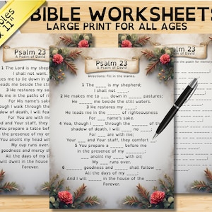 May include: Three printable Bible worksheets, 8.5 x 11 inches, featuring Psalm 23. The worksheets have a decorative floral border and are designed with large print for all ages. A black pen rests on one of the worksheets.