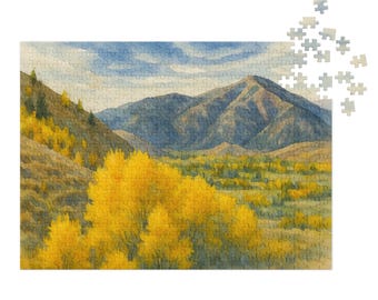 May include: A completed jigsaw puzzle depicting a watercolor landscape scene. The image shows a mountain range with a valley filled with yellow trees. The sky is blue with a few clouds. Some puzzle pieces are separate.