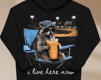 Funny Raccoon Ballfield Baseball Field I Live Here Now T-Shirt PNG, Raccoon Drinking Iced Coffee Mom Shirt Design