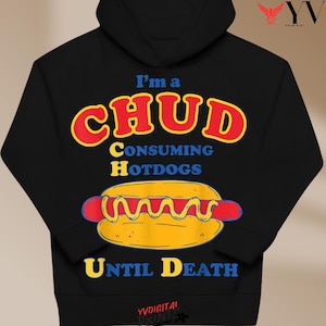 May include: Black hoodie with the text "I'm a CHUD Consuming Hotdogs Until Death" in red, yellow, and blue. A cartoon hotdog with mustard is featured below the text. The hoodie has a drawstring hood.