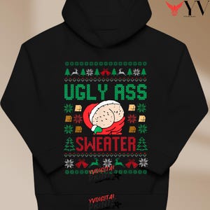 May include: Black hooded sweatshirt with a humorous Christmas design. The graphic reads "UGLY ASS SWEATER" in green, with a cartoon butt in a Santa Claus outfit. The design includes Christmas trees, snowflakes, and reindeer, creating a festive look.