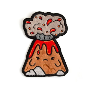 May include: An embroidered iron-on patch of a cartoon volcano with a grumpy face, red lava, and a gray smoke cloud with red sparks.