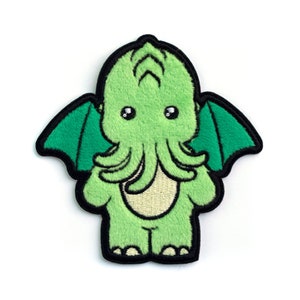 May include: Green plush patch of a cartoon Cthulhu with large eyes and wings.