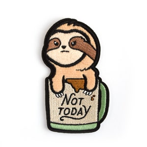 May include: Embroidered iron-on patch featuring a brown sloth sitting in a green coffee mug with the text "Not Today".
