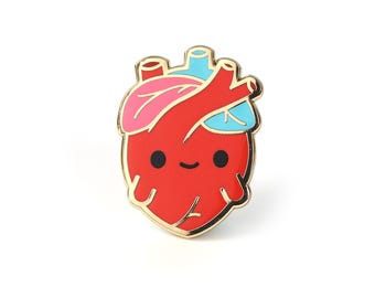 May include: A red enamel pin in the shape of a cartoon heart with a gold border. The heart has pink and blue accents, black eyes, and a smiling mouth. This cute pin is a fun accessory.