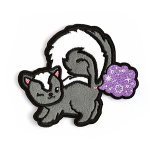 May include: Embroidered patch featuring a cartoon skunk with a winking expression. The skunk is gray and white with a black outline. A purple cloud with white floral designs emanates from the skunk's rear. The patch is designed for application on clothing or accessories.