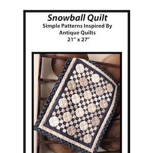 May include: A blue and white patchwork quilt with a snowball design. The quilt is 21 inches by 27 inches. The quilt is on a wooden surface with a brown bowl behind it. The text "Snowball Quilt" is at the top of the image. The text "Simple Patterns Inspired By Antique Quilts" is below the title. The text "21" x 27" is below the subtitle. The text "AP Quilts Annette Plog Quilts" is at the bottom of the image. The text "www.petitequilts.etsy.com copyright 2021" is at the bottom right of the image.