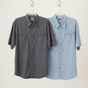 May include: Two short-sleeve button-down shirts hanging on plastic hangers. One shirt is dark charcoal gray and the other is light blue denim. Both shirts feature a classic collar, a front button placket, and two chest pockets with button flaps.