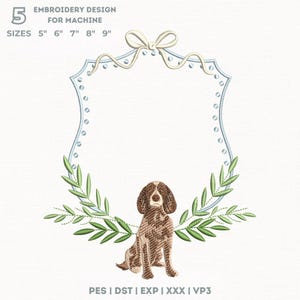 Könnte beinhalten: Ein Stickdesign für die Maschine, das einen sitzenden braun-weißen Hund in einem hellblauen, schildförmigen Rahmen zeigt. Der Rahmen ist mit einer weißen Schleife und Olivenzweigen verziert. Verfügbare Größen: 12.7cm, 15.2cm, 17.8cm, 20.3cm und 22.9cm.