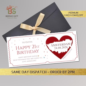 May include: A birthday card with a red heart-shaped design and the word "Amsterdam" and the date "24.08.2026". The card is white with red text and is inside a dark gray envelope tied with a beige ribbon. The text reads "Happy 21st Birthday".