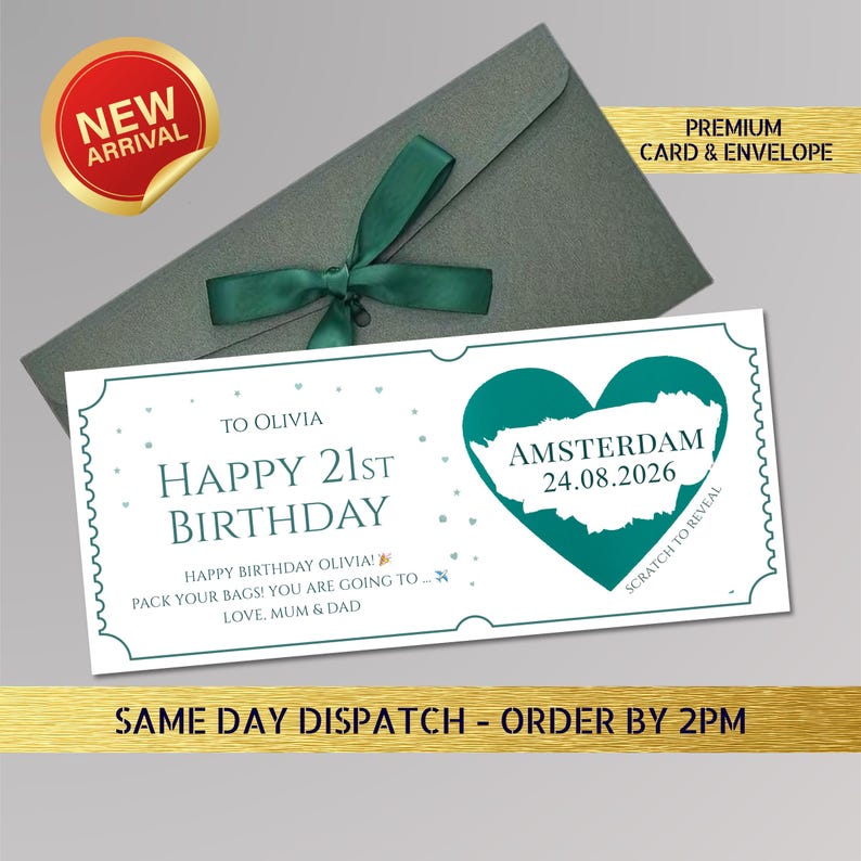 May include: A birthday card with a teal heart-shaped graphic of Amsterdam and the text "Happy 21st Birthday". The card is paired with a gray envelope tied with a green ribbon. A "New Arrival" sticker is visible.