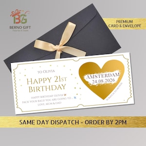May include: A birthday gift card with a gold heart and the text "Happy 21st Birthday". The card is white with gold accents and a black envelope tied with a beige ribbon. The card says "Amsterdam 24.08.2026" and "Scratch to Reveal".