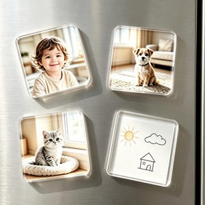May include: Four square refrigerator magnets with clear acrylic frames. One magnet features a smiling child, one shows a small brown and white dog, one displays a grey tabby kitten, and one contains a simple line drawing of a sun, cloud, and house.