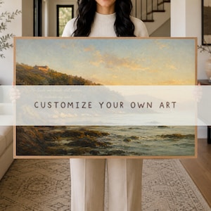 May include: A rectangular landscape painting in a wooden frame depicting a coastal scene at sunset with a house on a cliff, rocky shoreline, and calm water. The text "He leads me beside still waters. He restores my soul. CUSTOMIZE YOUR OWN ART" is visible.