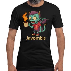 May include: Black t-shirt featuring a cartoon zombie character with green skin, holding a coffee cup with flames. The character has horns, wings, and the word "Javombie" in yellow text below. The shirt is short-sleeved.