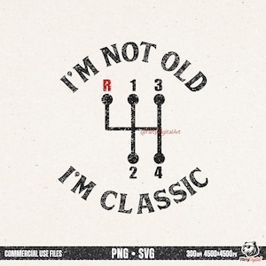 May include: A graphic design featuring a black gear shift pattern with the text "I'M NOT OLD I'M CLASSIC" in a distressed font. The reverse gear is red. The design is on a cream-colored background.