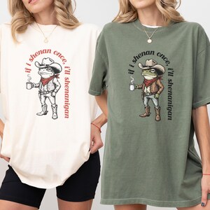 funny frog cowboy st patricks day png, retro shenanigan frog shirt design, vintage western irish green frog, frog riding cowboy funny illustration, st paddys day green frog art, distressed green cowboy frog sublimation, whimsical irish shenanigan digital download, lucky frog cowboy hat western png, funny st patricks day humor for adults, vintage woodcut style frog cowboy design
