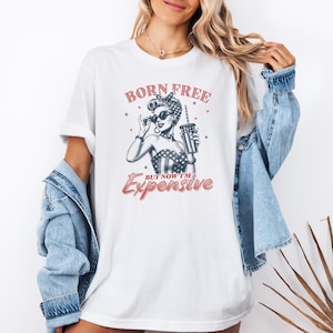 born free expensive png, retro patriotic girl sublimation, funny 4th of july digital art, vintage pinup independence day, sarcastic semiquincentennial design, woodcut style patriotic woman, usa 250th anniversary graphic, charcoal black engraving print, vintage red 4th july typography, sassy american flag girl