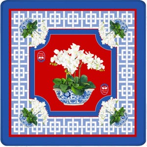 May include: Square decorative item with a red center, blue border, and white geometric pattern. Features a white orchid in a blue and white patterned bowl. Smaller bowls with white flowers are in each corner.