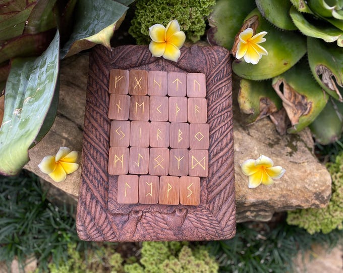 Handcrafted Divination Runes made from selected Iron wood, featuring gold-painted symbols in traditional Balinese style. Elder Futhark runes