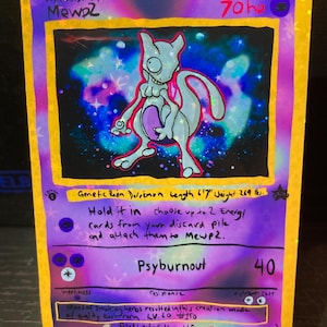 May include: A custom-made Pokémon card featuring Mewtwo. The card has a purple background with a galaxy design and a light blue Mewtwo illustration. Text includes "Mewp2", "Psyburnout", and other game details. The card is 6'7" long and weighs 269 lbs.
