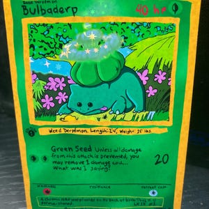 May include: A custom-made Bulbadep Pokémon card with a green and yellow design. The card features a green creature with a bulb on its back, the text "Bulbaderp", and the text "Green Seed". The card measures 2'4" in length and weighs 15 lbs.